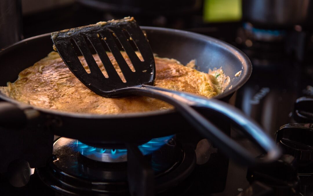 black spatula on pan. Photo by Caio on Pexels